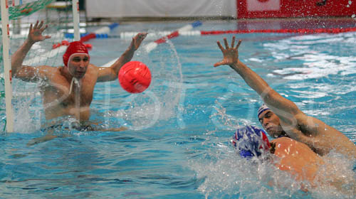 Aurelien Cousin of France (blue cap) shooting on goal and scoring during first match of qualification waterpolo tournament for European championship. Match between Slovenia and France took place in Kranj, Slovenia on 7.April 2006. Slovenia defeated France with 9:7. 